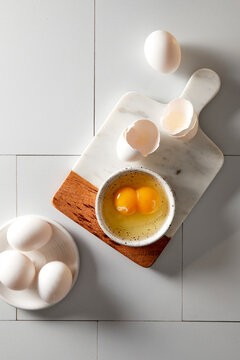 Egg with a double yolk cracked in a small bowl