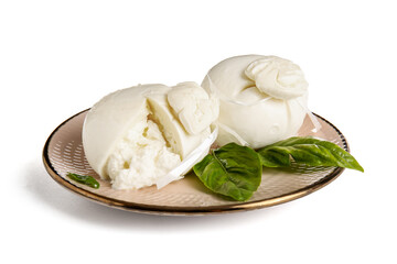 Plate of tasty Burrata cheese with basil on white background