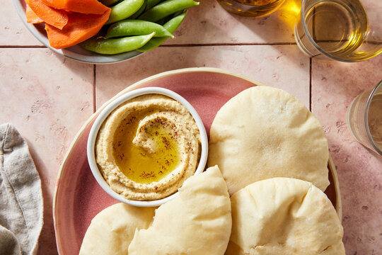 Pita Bread and Hummus on Pink Tile