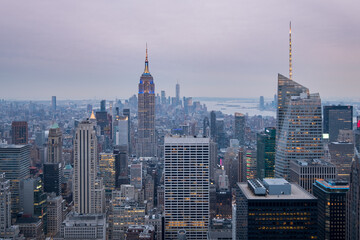 Panoramic view of the Manhattan skyline at sunset, with the Empire State Building in the foreground