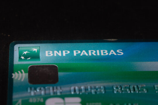 PARIS, FRANCE - APRIL 15, 2023: Selective blur on a BNP Paribas logo on a credit and debit card, a french carte bleue. BNP Paribas is a French bank, one of the biggest in France and in Europe