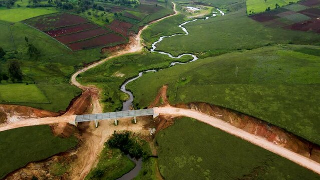 Climate change concept cop Kenya. Birdseye aerial view of Africa Kenya, shanty poor neighborhood of West pokot, Kenya. Low populated area with water stream, top down drone shot.