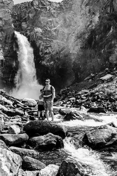 Father and son in the mountains. Black and white toned image 