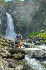 Father and son at waterfall 