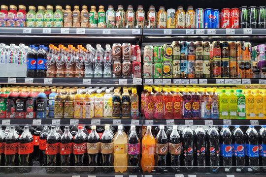 PENANG, MALAYSIA - 30 JULY 2023: Within a convenience store in Penang, an interior view unveils a large fridge stocked with a variety of beverages from different brands.
