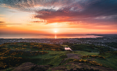 The view of the Holyrood Park and the habour area of Edinburgh in the sunrise 