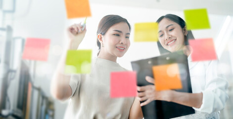 Collaboration and analysis by asian businesswoman working in office