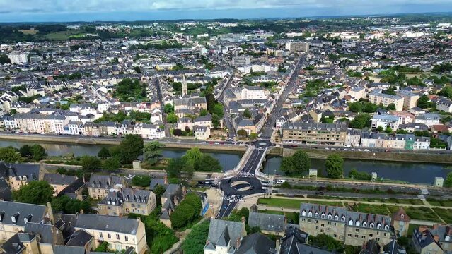 Le Mans cityscape with bridge and Sarthe river flowing in France. Aerial drone flyback
