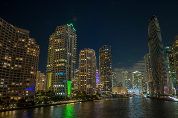 Fototapeta na wymiar View from above of brightly illuminated high skyscraper buildings in downtown district of Miami Brickell in Florida, USA. American megapolis with business financial district at night