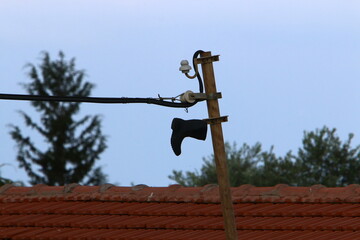Power electric pole with line wires on insulators.