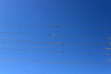 Power electric pole with line wires on insulators.