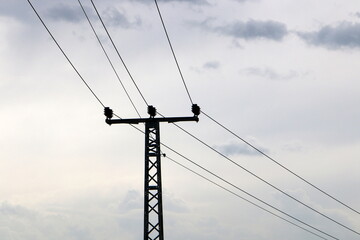 Power electric pole with line wires on insulators.