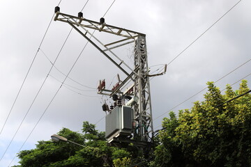 Power electric pole with line wires on insulators.