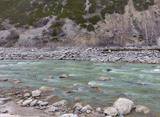 A river, a spring evening in a mountainous area, the state of the weather before the rain, low clouds.