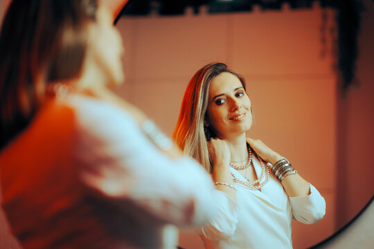 Woman Trying On Pearl Necklace Looking In The Mirror. Lady Wearing Gorgeous Vintage Expensive Luxury Accessory 
