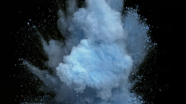 Blue Powder exploding against black background. Shot with high speed camera, Slow Motion,Super slow motion of coloured powder collision isolated on black background. 