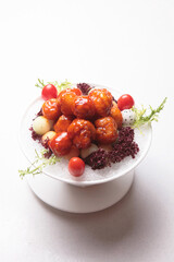 stir fried sweet and sour pork meatball in ice bowl salad on white background fusion asian halal food menu for chinese banquet restaurant