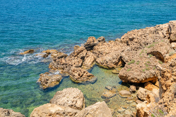 View of the rocky shore and crystal clear water of the Aegean Sea, Agioi Apostoloi village, Daratsos, Chania, Crete, Greece