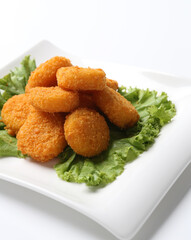 deep fried crispy golden scallops or chicken or fish nugget green salad in plate on white background design appetiser food dim sum snack halal menu for Hong Kong cafe