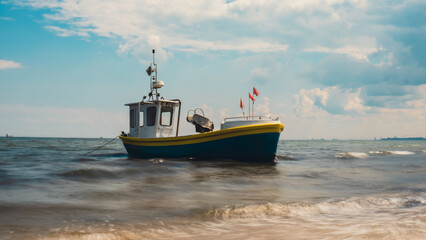 Fishing boat on the beach in Sopot, Poland. Magnificent long exposure calm Baltic Sea. Wallpaper defocused waves. Fishermans sea bay Vacation and holidays. travel attraction tourist destination 