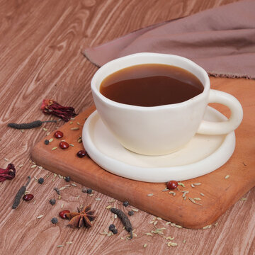 cup of coffee with cinnamon sticks and cinnamon