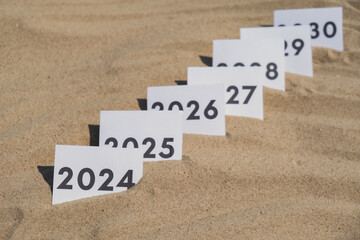 Paper cards with numbers of years from 2024 to 2030 in a row. New year start concept. Resolution...