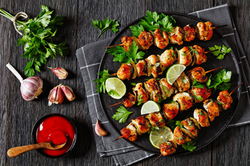 chicken souvlaki with parsley and lime on plate