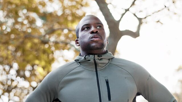 Fitness, thinking and a tired man outdoor for exercise break, rest or to breathe after a run or workout. African person, athlete or runner in nature for health, wellness and training for sports