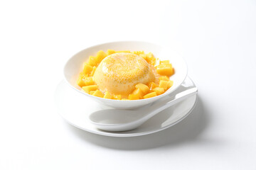 chilled mango sago fruit with pomelo and soya pudding jelly in white bowl on clean background sweet dessert pastry menu for Hong Kong cafe