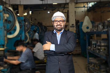Indian businessman standing at factory