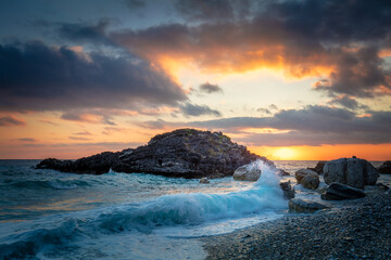 Obraz premium Seascape. Sea Ocean Morning. Wave hit the rock at beach, sea water splash up to the sky with sun. Sunset Sundown at Sea. Storm. Seascape. Nature Background