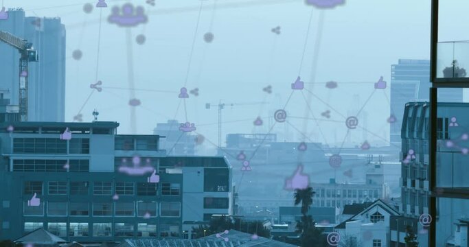 Animation of network of digital icons against aerial view of cityscape