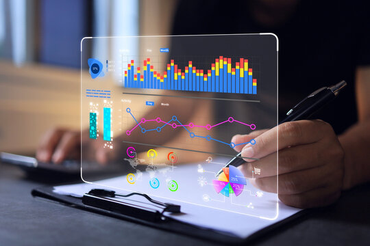 Businessman reading data in bar graph and pie chart form on virtual data analytic dashboard in office. Business analysis for investment and online digital marketing