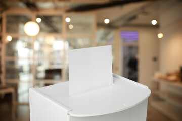 Ballot box with vote on blurred background