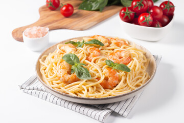 Italian pasta spaghetti with soft cheese sauce with shrimp or prawns on a plate