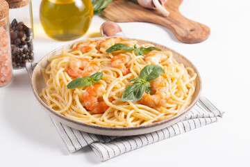 Italian pasta spaghetti with soft cheese sauce with shrimp or prawns on a plate