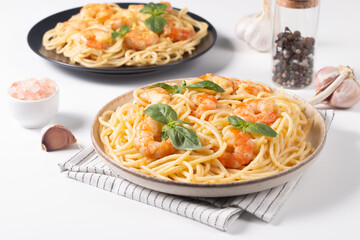 Italian pasta spaghetti with soft cheese sauce with shrimp or prawns on a plate