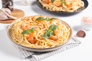 Italian pasta spaghetti with soft cheese sauce with shrimp or prawns on a plate