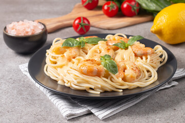 Italian pasta spaghetti with soft cheese sauce with shrimp or prawns on a plate