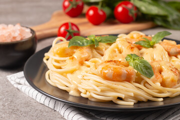 Italian pasta spaghetti with soft cheese sauce with shrimp or prawns on a plate