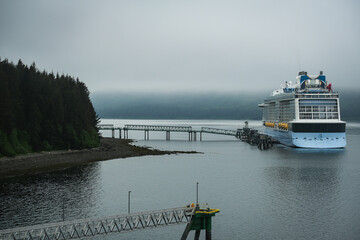 Coast bay view with modern cruiseship cruise ship liner Quantum in front of Alaska mountains on...