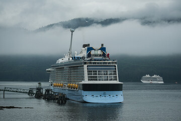 Coast bay view with modern cruiseship cruise ship liner Quantum in front of Alaska mountains on...