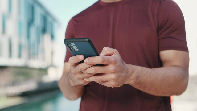 Man, phone and hands typing in city for outdoor communication, networking or online browsing. Closeup of male person chatting, texting or social media on mobile smartphone app in an urban town