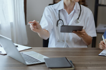 Two female doctor working at desk in clinic office, Teamwork in medicine and healthcare concept.