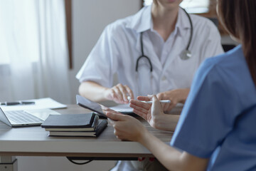 Two female doctor working at desk in clinic office, Teamwork in medicine and healthcare concept.	