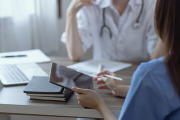 Two female doctor working at desk in clinic office, Teamwork in medicine and healthcare concept.	