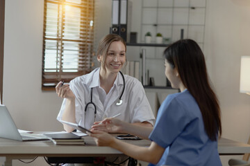 Two female doctor working at desk in clinic office, Teamwork in medicine and healthcare concept.	