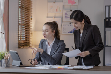 Group of businesswoman team working with analysis financial data visualization tech for marketing strategy, Businesswoman accountant or financial report graph at desk in corporate office.