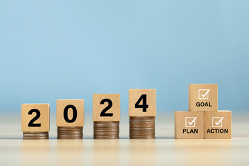 2024 Action Plan.Cubes with text 2024 and goal, plan, and action on coins stack.Business...