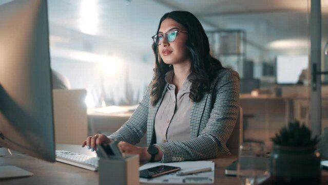 Business woman, computer and typing of research, editing article and website copywriting in office at night. Professional writer, editor or journalist working on desktop pc in glasses for information